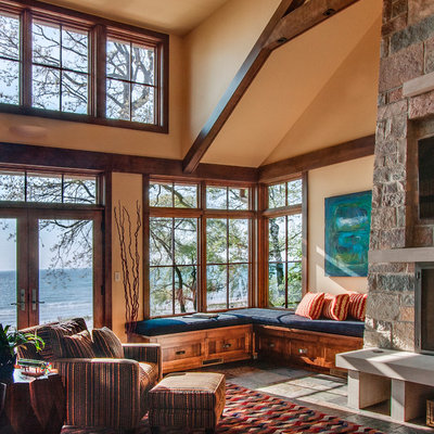 Mountain style family room photo in Milwaukee with a stone fireplace