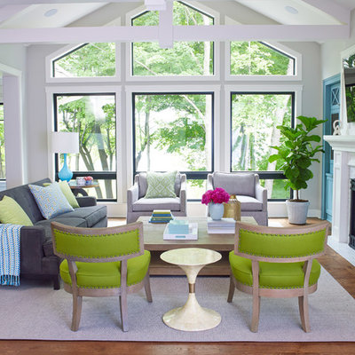 Inspiration for a coastal medium tone wood floor family room remodel in Minneapolis with gray walls, a standard fireplace and a wall-mounted tv