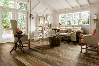 Inspiration for a mid-sized country open concept medium tone wood floor family room remodel in St Louis with white walls and no fireplace
