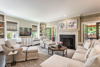 Transitional dark wood floor family room photo in Other with beige walls, a standard fireplace and a wall-mounted tv