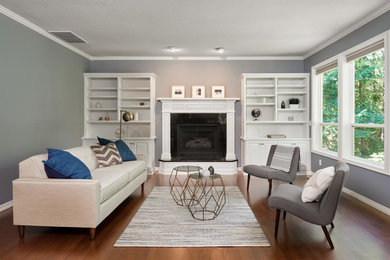 Inspiration for a large timeless open concept medium tone wood floor family room remodel in Portland with blue walls, a standard fireplace, a tile fireplace and no tv