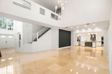 Inspiration for a large contemporary open concept marble floor and beige floor family room remodel in Miami with white walls
