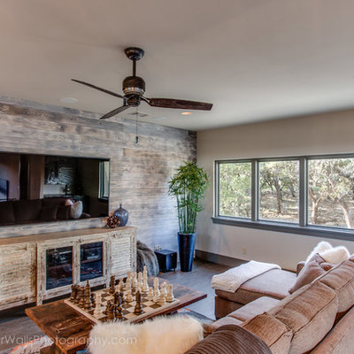 Inspiration for a mid-sized rustic enclosed medium tone wood floor family room remodel in Austin with a bar, beige walls, no fireplace and a wall-mounted tv