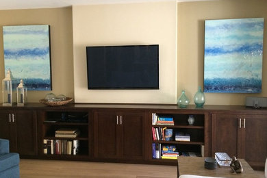 Photo of a medium sized contemporary open plan games room in Other with beige walls, light hardwood flooring and a wall mounted tv.