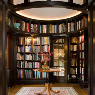 Large elegant enclosed dark wood floor and brown floor family room library photo in New York