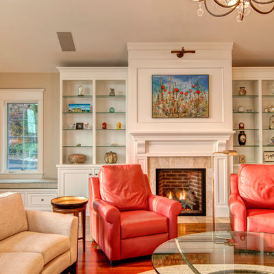 Example of a classic dark wood floor family room design in Other with beige walls, a standard fireplace and a tile fireplace