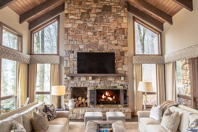 Inspiration for a large rustic open concept family room remodel in Charlotte with a stone fireplace, white walls, a standard fireplace and a wall-mounted tv