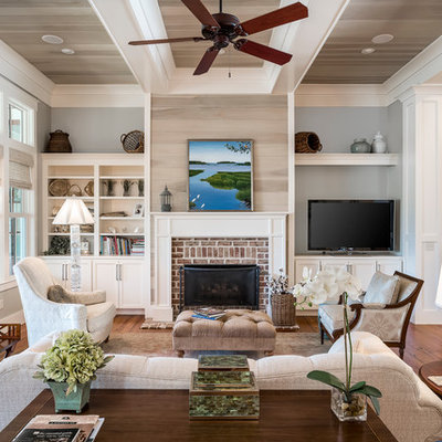 Family room - large transitional open concept medium tone wood floor family room idea in Charleston with gray walls, a standard fireplace, a brick fireplace and a media wall