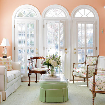 Family room - traditional enclosed medium tone wood floor family room idea in Atlanta with pink walls and no tv