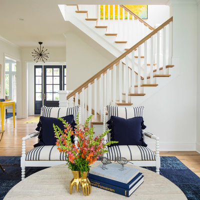 Family room - large coastal open concept light wood floor and brown floor family room idea in Minneapolis with white walls, a standard fireplace, a wood fireplace surround and a wall-mounted tv