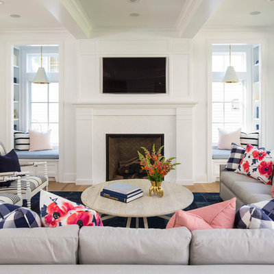 Inspiration for a large coastal open concept light wood floor and brown floor family room remodel in Minneapolis with white walls, a standard fireplace, a wall-mounted tv and a wood fireplace surround