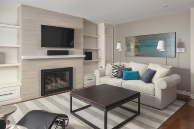 Trendy open concept light wood floor family room photo in Toronto with beige walls, a standard fireplace, a tile fireplace and a wall-mounted tv