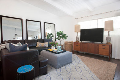 Example of a mid-sized transitional open concept dark wood floor family room design in Los Angeles with white walls, no fireplace and a tv stand