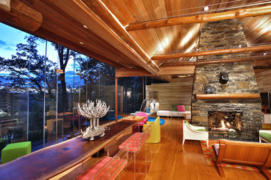 Inspiration for an eclectic open concept family room remodel in DC Metro with a standard fireplace and a stone fireplace