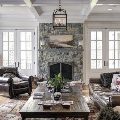 Family room - traditional medium tone wood floor family room idea in DC Metro with beige walls, a standard fireplace and a stone fireplace