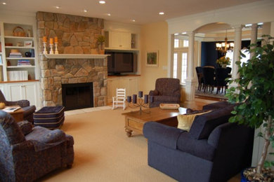 Example of a mid-sized classic carpeted and beige floor family room design in Boston with beige walls, a standard fireplace, a stone fireplace and a corner tv