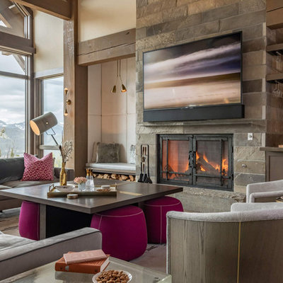 Mountain style open concept family room photo in Other with a bar, beige walls, a standard fireplace, a stone fireplace and a wall-mounted tv