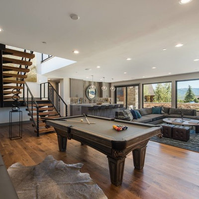 Example of a mountain style open concept medium tone wood floor family room design in Miami with beige walls