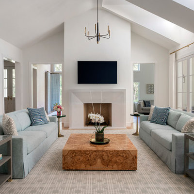 Family room - large transitional enclosed light wood floor family room idea in Dallas with white walls, a standard fireplace, a stone fireplace and a wall-mounted tv