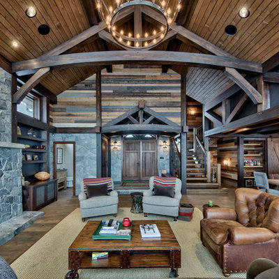 Example of a large mountain style open concept medium tone wood floor family room design in Vancouver with a standard fireplace, a stone fireplace and a wall-mounted tv