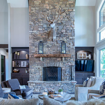 Luxurious Great room with stone fireplace.  Custom built ins