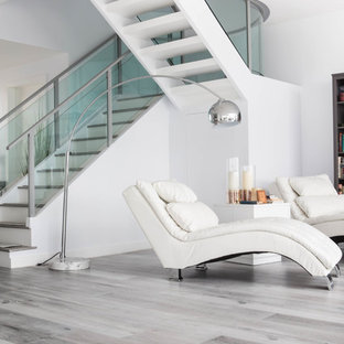 Family room library - large modern open concept laminate floor and multicolored floor family room library idea in Los Angeles with white walls