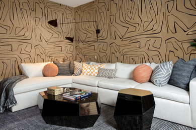 Inspiration for a mid-sized contemporary enclosed black floor and wallpaper family room remodel in San Francisco with beige walls and a wall-mounted tv