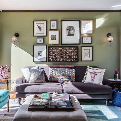 Example of a mid-sized eclectic enclosed medium tone wood floor and brown floor family room design in Denver with green walls and a wall-mounted tv