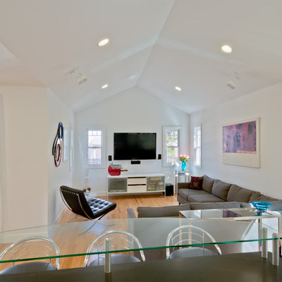 Mid-sized trendy open concept medium tone wood floor family room photo in Detroit with white walls and a wall-mounted tv