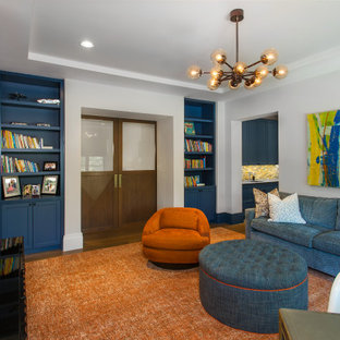 Example of a tuscan enclosed family room library design in Dallas with gray walls, no fireplace and a wall-mounted tv
