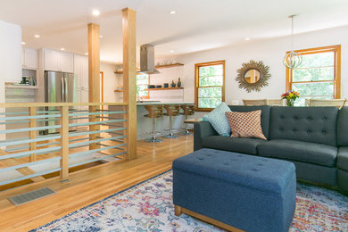 Example of a small 1960s open concept light wood floor and brown floor family room design in Atlanta with white walls
