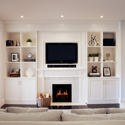 Example of a transitional dark wood floor family room design in Toronto with a standard fireplace and a wall-mounted tv