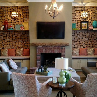Example of a mid-sized mountain style enclosed dark wood floor family room design in Raleigh with green walls, a standard fireplace, a brick fireplace and a wall-mounted tv