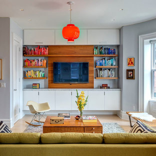 Example of a mid-sized 1960s enclosed light wood floor family room library design in Other with gray walls, no fireplace and a wall-mounted tv