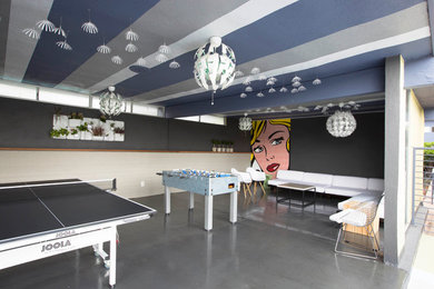 Design ideas for a contemporary open plan games room in Los Angeles with a game room, grey walls and concrete flooring.