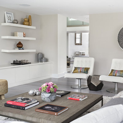 Trendy enclosed gray floor family room photo in New York with gray walls, no fireplace and a wall-mounted tv