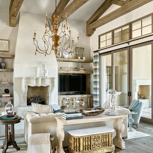 Tuscan open concept dark wood floor family room photo in Los Angeles with white walls, a standard fireplace and a wall-mounted tv