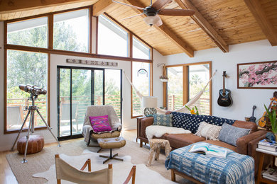 Example of an eclectic family room design in Santa Barbara with white walls