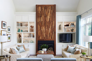 Inspiration for a large transitional open concept dark wood floor family room remodel in Toronto with beige walls, a standard fireplace, a wood fireplace surround and a media wall