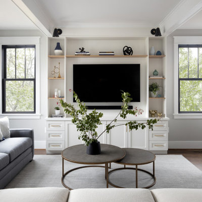 Example of a transitional open concept dark wood floor and brown floor family room design in DC Metro with gray walls and a media wall