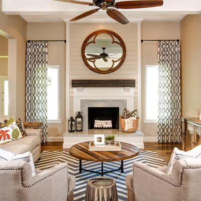Inspiration for a rustic open concept medium tone wood floor family room remodel in Phoenix with beige walls, a standard fireplace and a wall-mounted tv