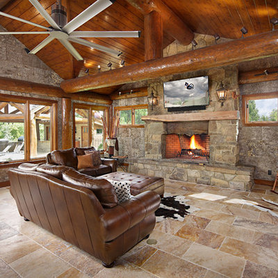 Family room - rustic family room idea in Boise with a standard fireplace, a stone fireplace and a wall-mounted tv