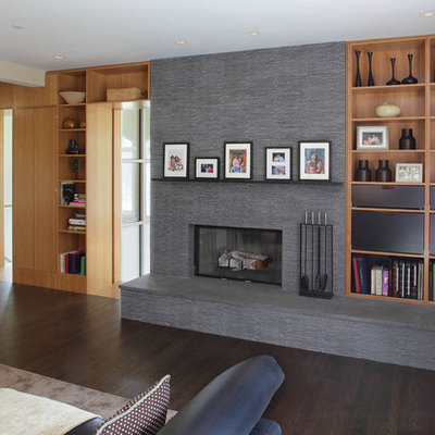 Trendy family room photo in New York with beige walls, a standard fireplace and a stone fireplace