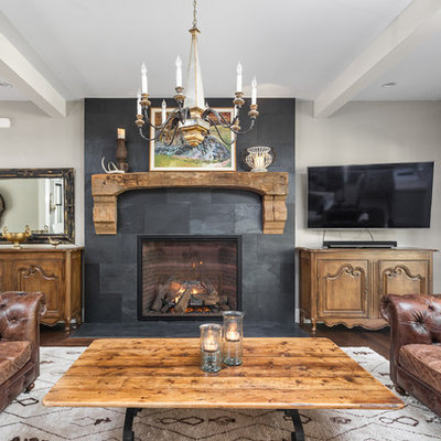 Inspiration for a country dark wood floor family room remodel in Indianapolis with gray walls, a standard fireplace, a tile fireplace and a wall-mounted tv
