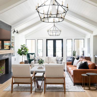 Family room - large cottage open concept light wood floor family room idea in Sacramento with a bar, white walls, a standard fireplace and a wall-mounted tv