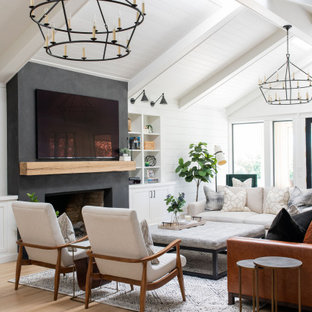 Example of a large farmhouse open concept light wood floor family room design in Sacramento with a bar, white walls, a standard fireplace and a wall-mounted tv