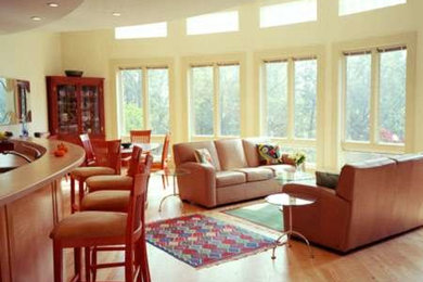 Family room - large contemporary open concept medium tone wood floor family room idea in Other with no fireplace, no tv and white walls