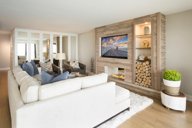 Family room - coastal light wood floor and beige floor family room idea in Chicago with beige walls, a two-sided fireplace, a tile fireplace and a wall-mounted tv