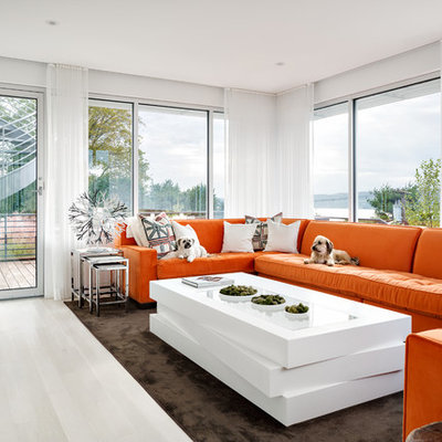 Mid-sized trendy enclosed light wood floor and white floor family room photo in New York with white walls, a wall-mounted tv and no fireplace