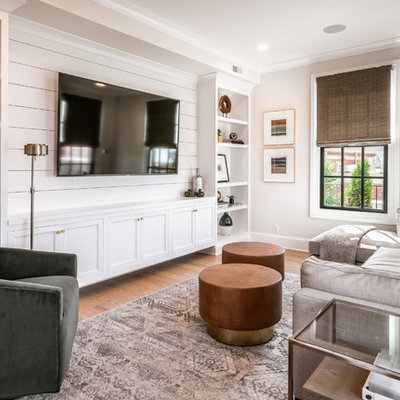 Inspiration for a transitional light wood floor family room library remodel in Louisville with gray walls, no fireplace and a media wall